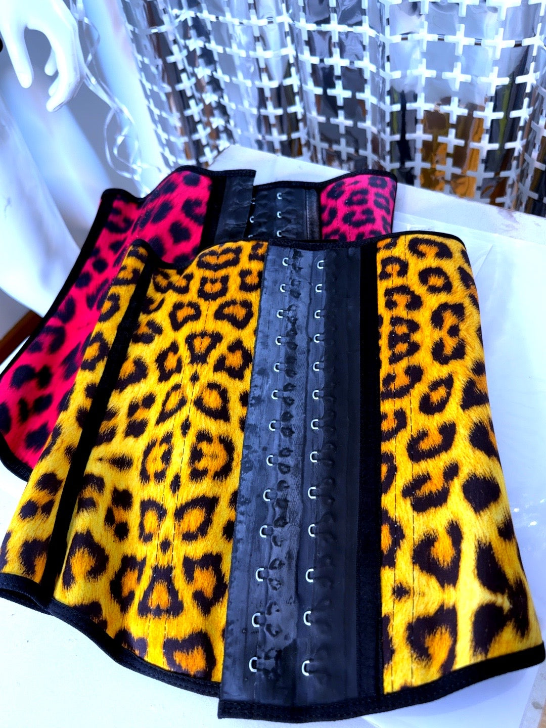 Leopard print waist trainer with pink accents on a white background